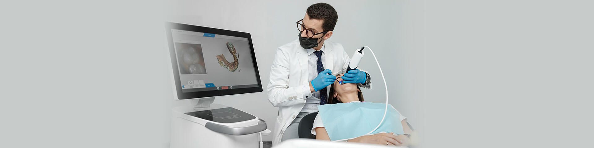 dentist scanning girl mouth with digital scanner